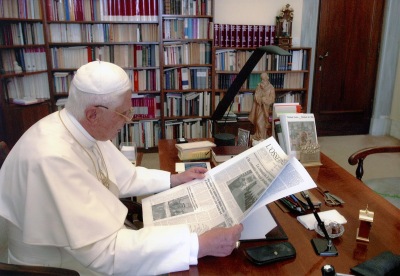 Pope Benedict reading a newspaper